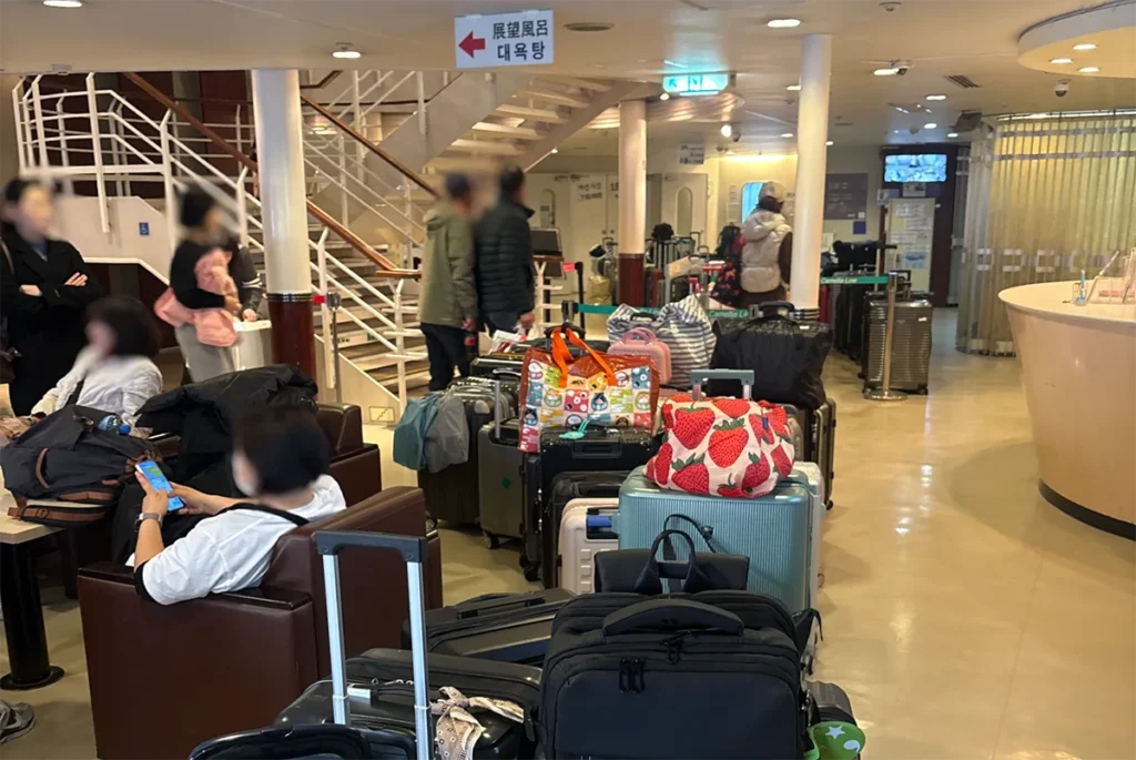 하카타항 뉴카멜리아호 수속을 빠르게 마치기 위해 3층 로비에 줄 세워진 승객들의 캐리어